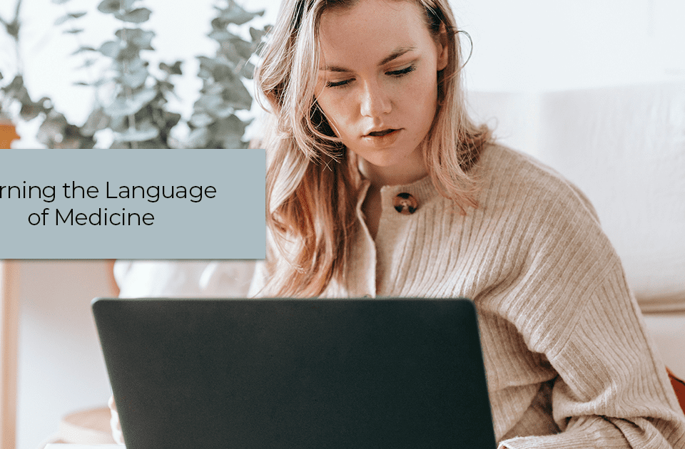 Woman studying on a laptop leaning the language of medicine