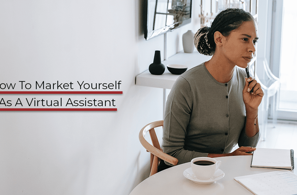 A young woman sitting at a white table brainstorming how to market yourself as a Virtual Assistant.