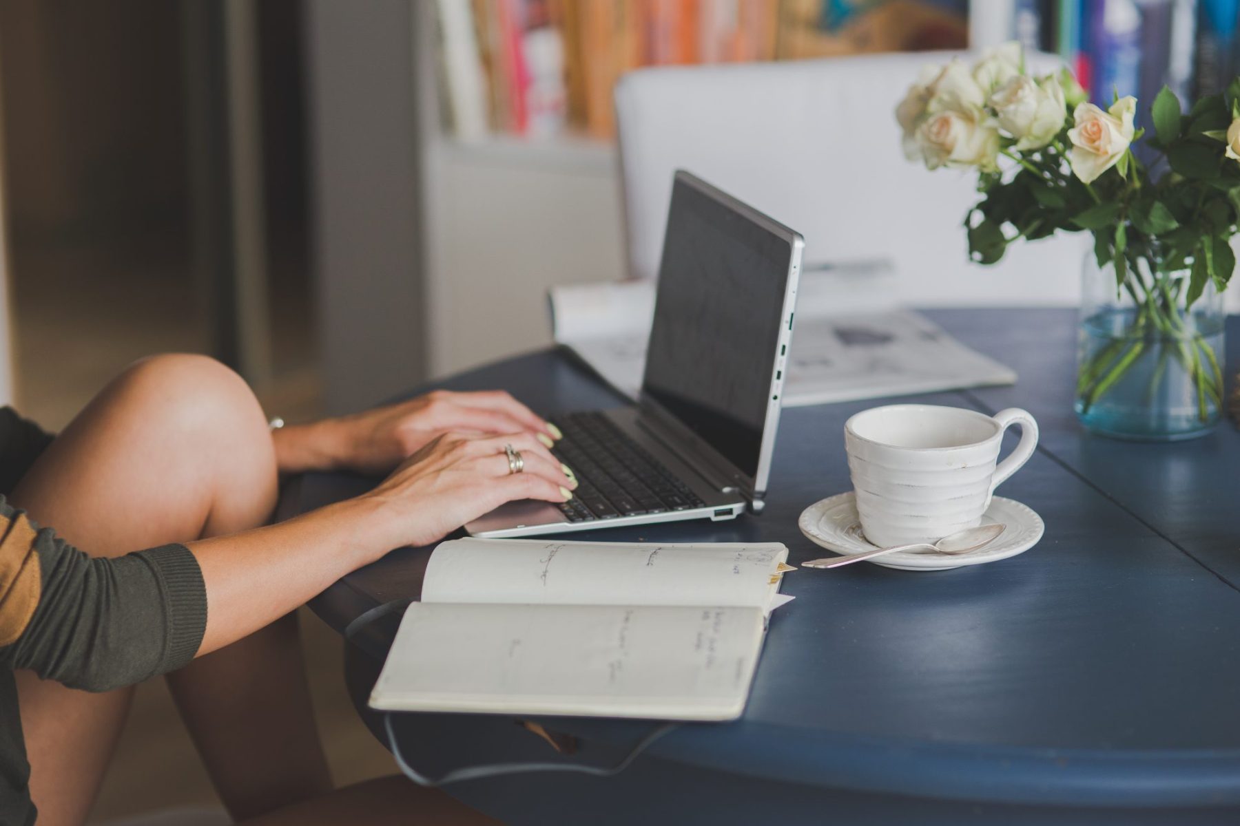 Woman typing on a computer taking online classes.